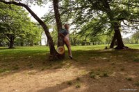 I show off my hips against a tree