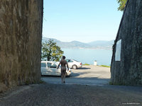 I wait in the shadows for the car to pass before crossing to reach the beach