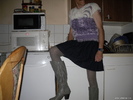 small speaker, mini pleated skirt and blue high-heeled boots